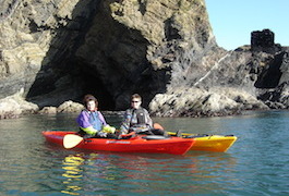 Two ladies kayaking off Pembrokeshire coast
